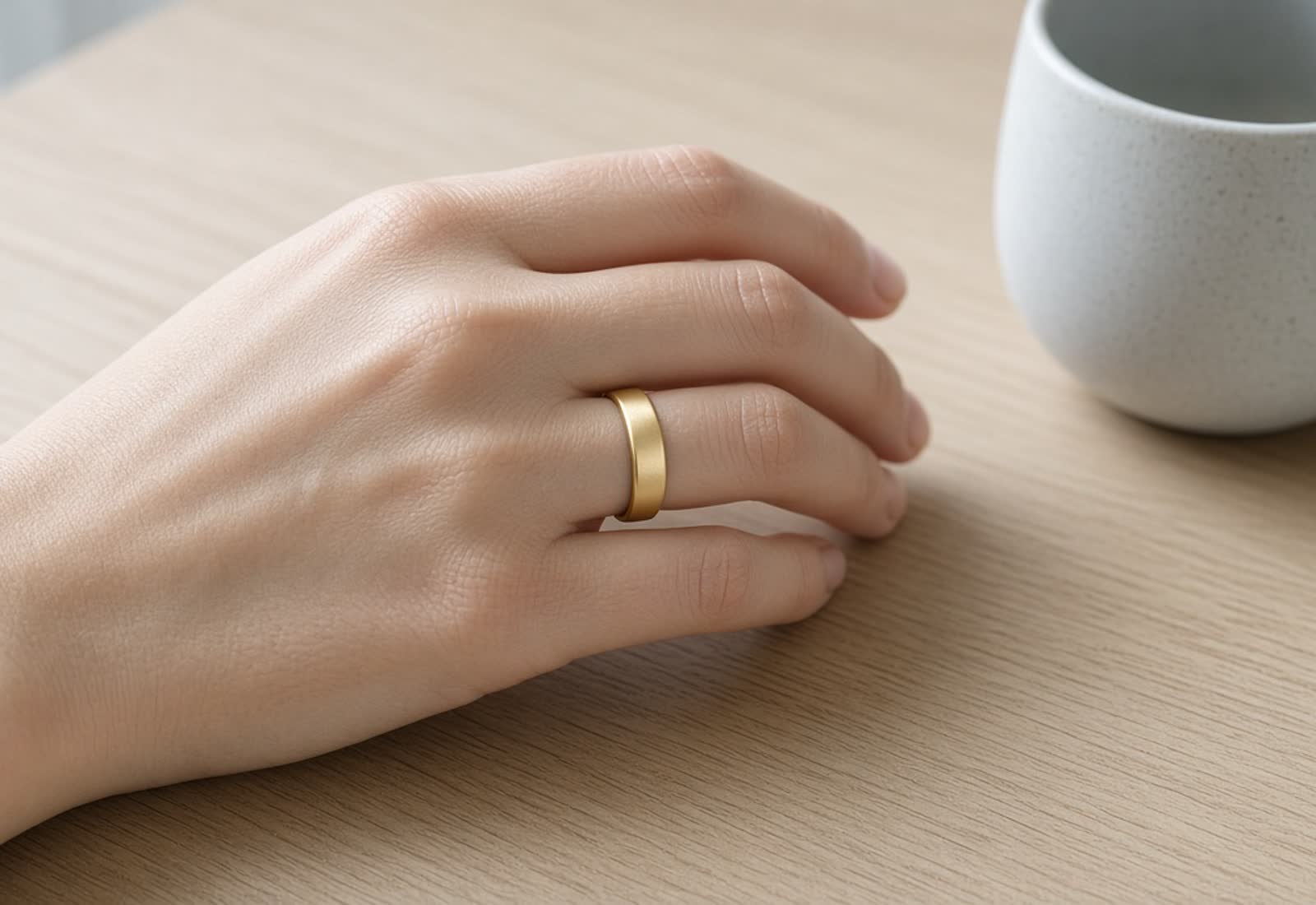 Editorial still of a gold Oura ring